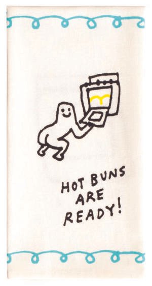 tea towel design with a cartoon figure with butcheeks visible, putting buns in an oven with the words "hot buns are ready"